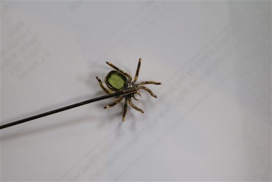 A yellow metal and gem set spider hat pin in original box, 17cm.